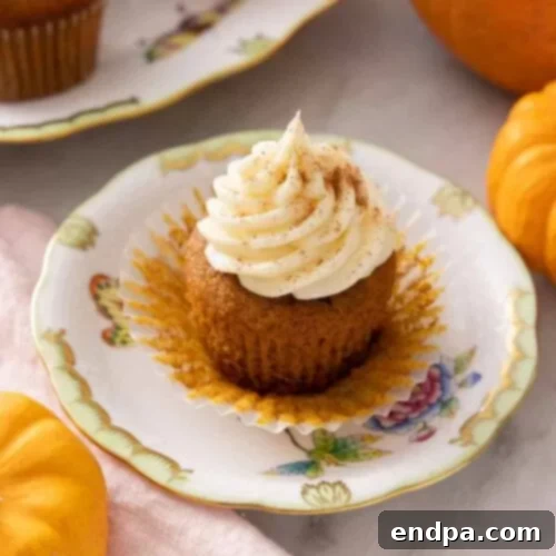 Delightful Pumpkin Cupcakes topped with cream cheese frosting.