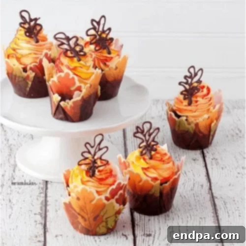 Chocolate cupcakes adorned with beautiful edible fall leaves.