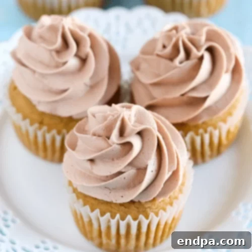 Moist Pumpkin Cupcakes generously frosted with creamy Nutella.