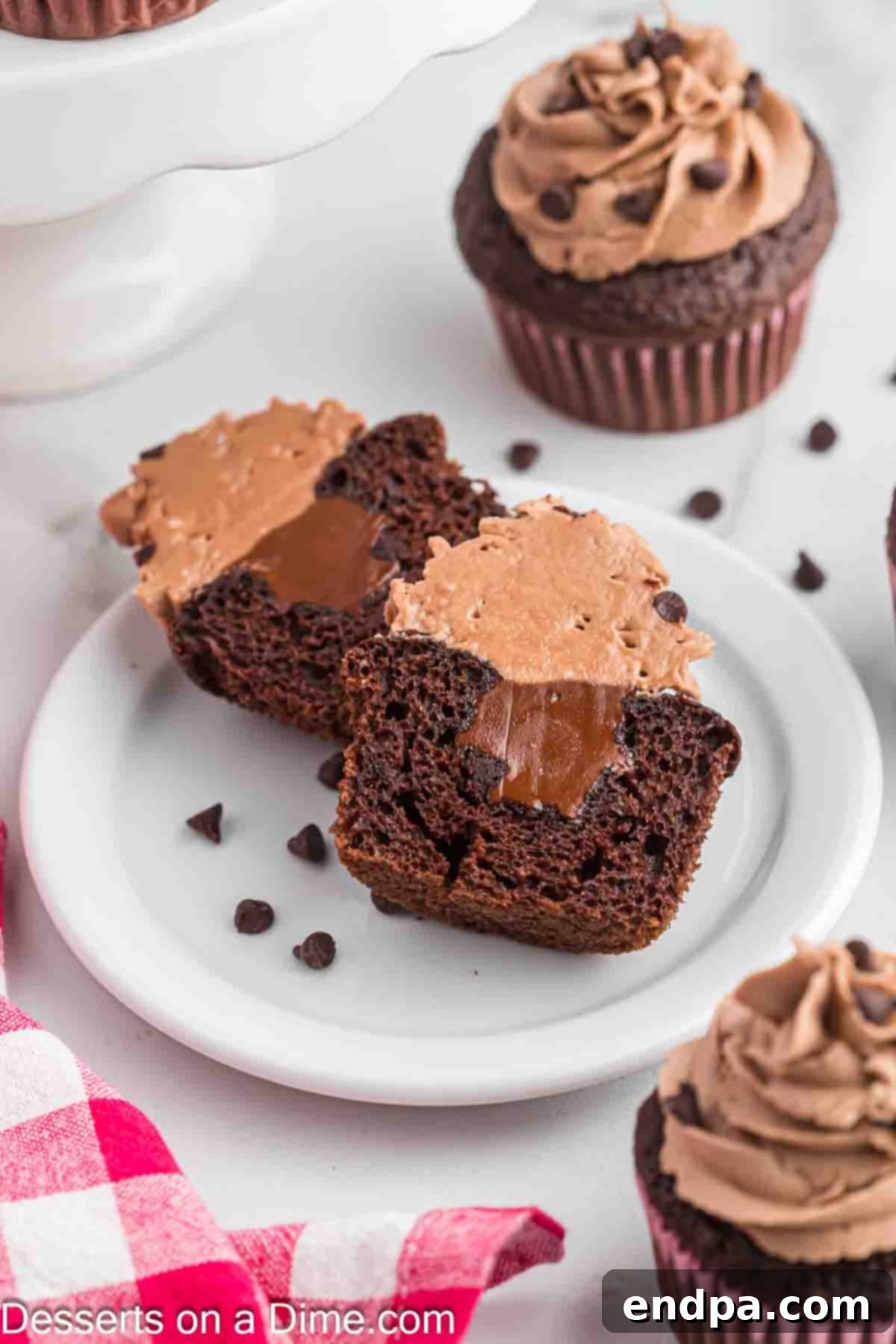 Nutella Cupcake with frosting cut in half on a plate.