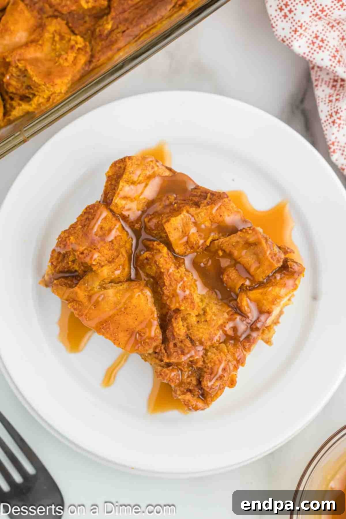 Pumpkin bread pudding with a serving on a plate