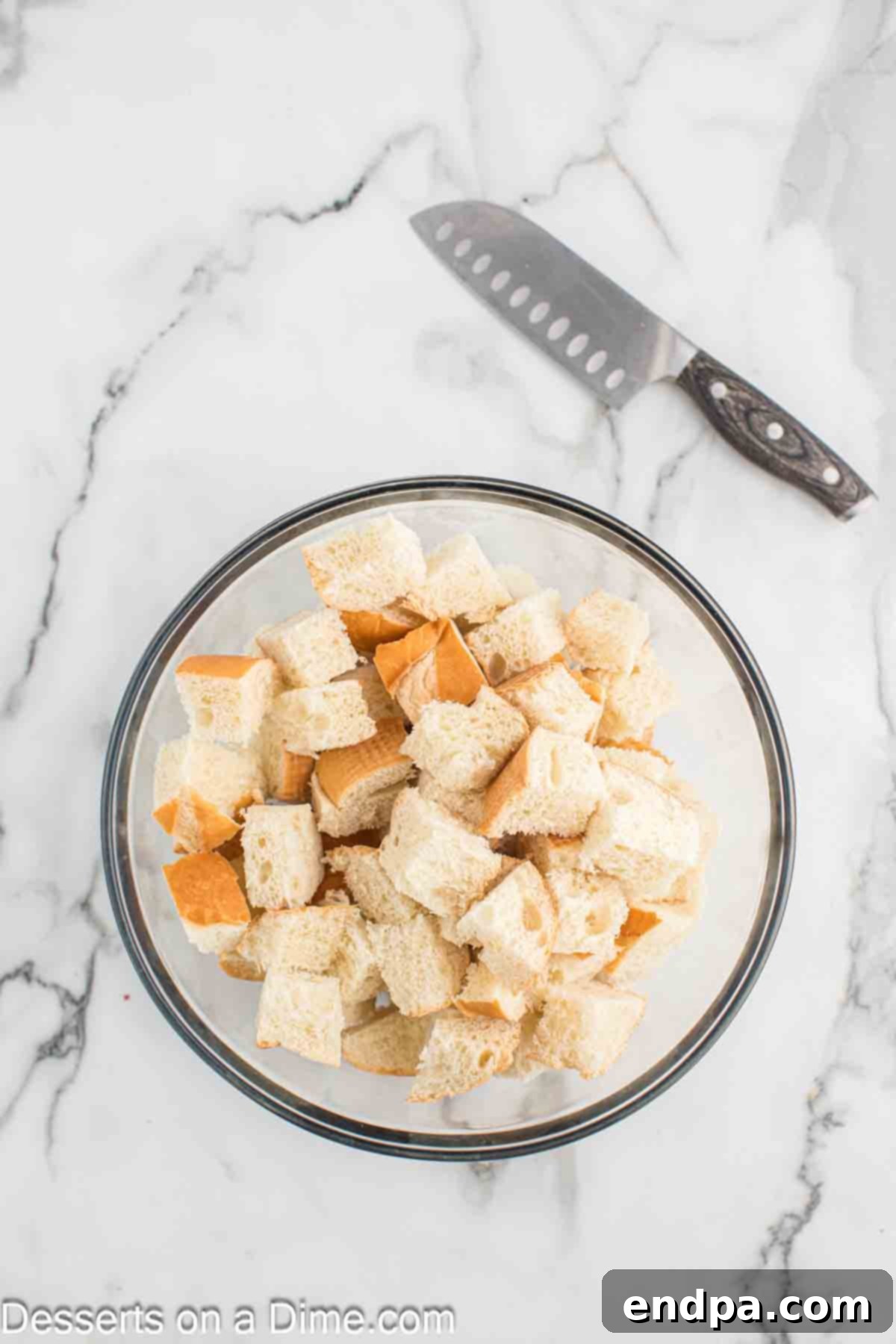 Bread cubed and placed in a bowl. 