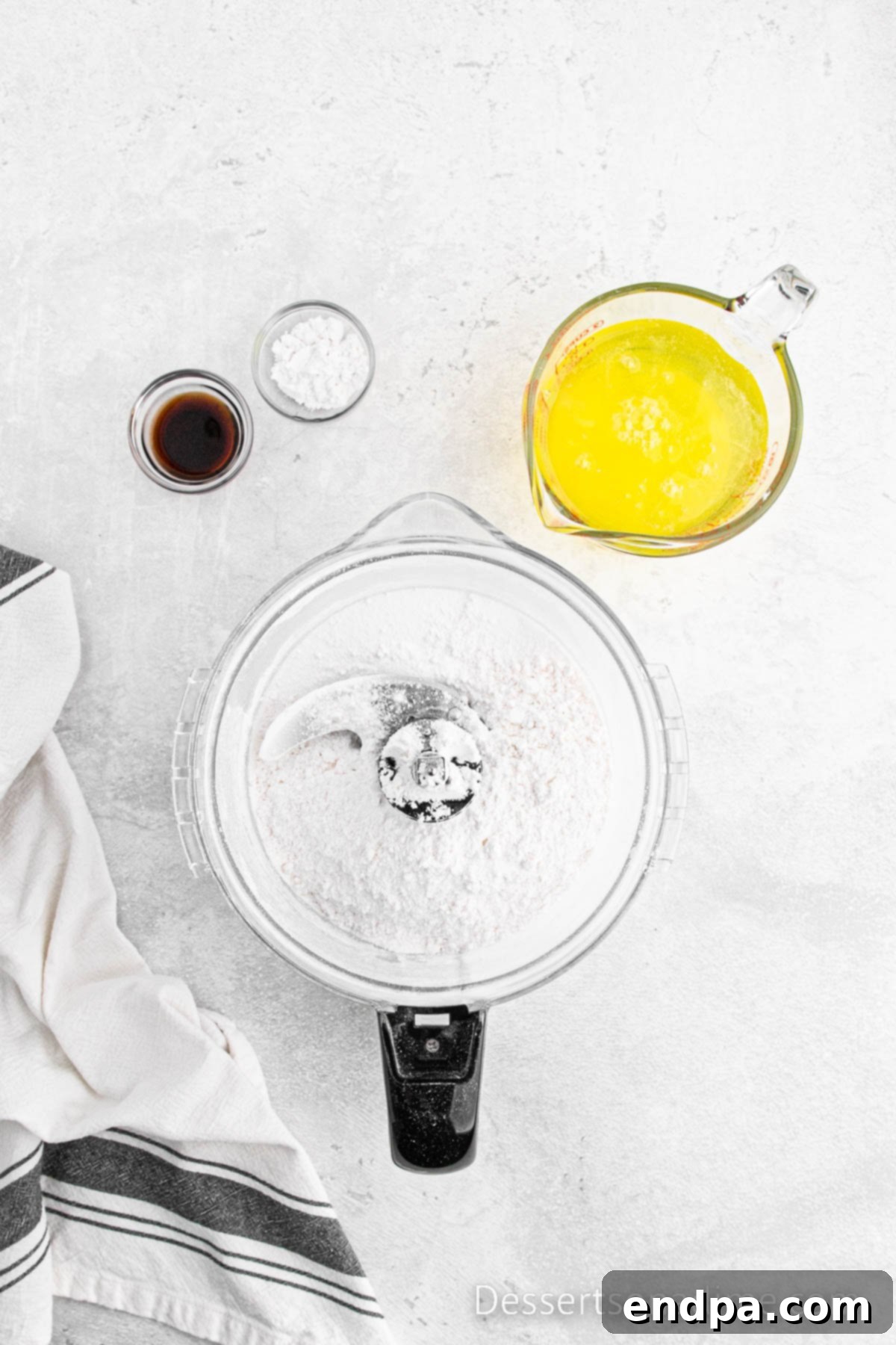 Cake flour and salt added to the remaining fine sugar in a food processor.