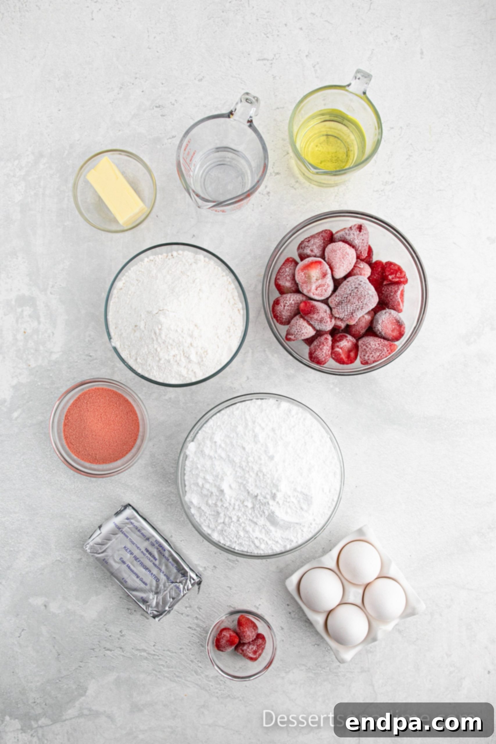 Paula Deen's Signature Strawberry Cake 3 Assorted ingredients laid out for Paula Deen Strawberry Cake, including butter, oil, frozen strawberries, powdered sugar, strawberry gelatin, cream cheese, and eggs.