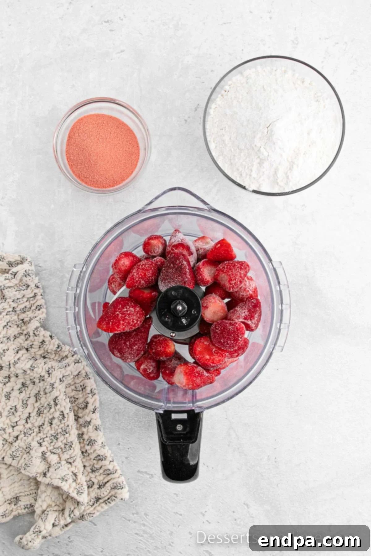 Paula Deen's Signature Strawberry Cake 4 Frozen strawberries being pureed in a food processor for the cake and frosting.