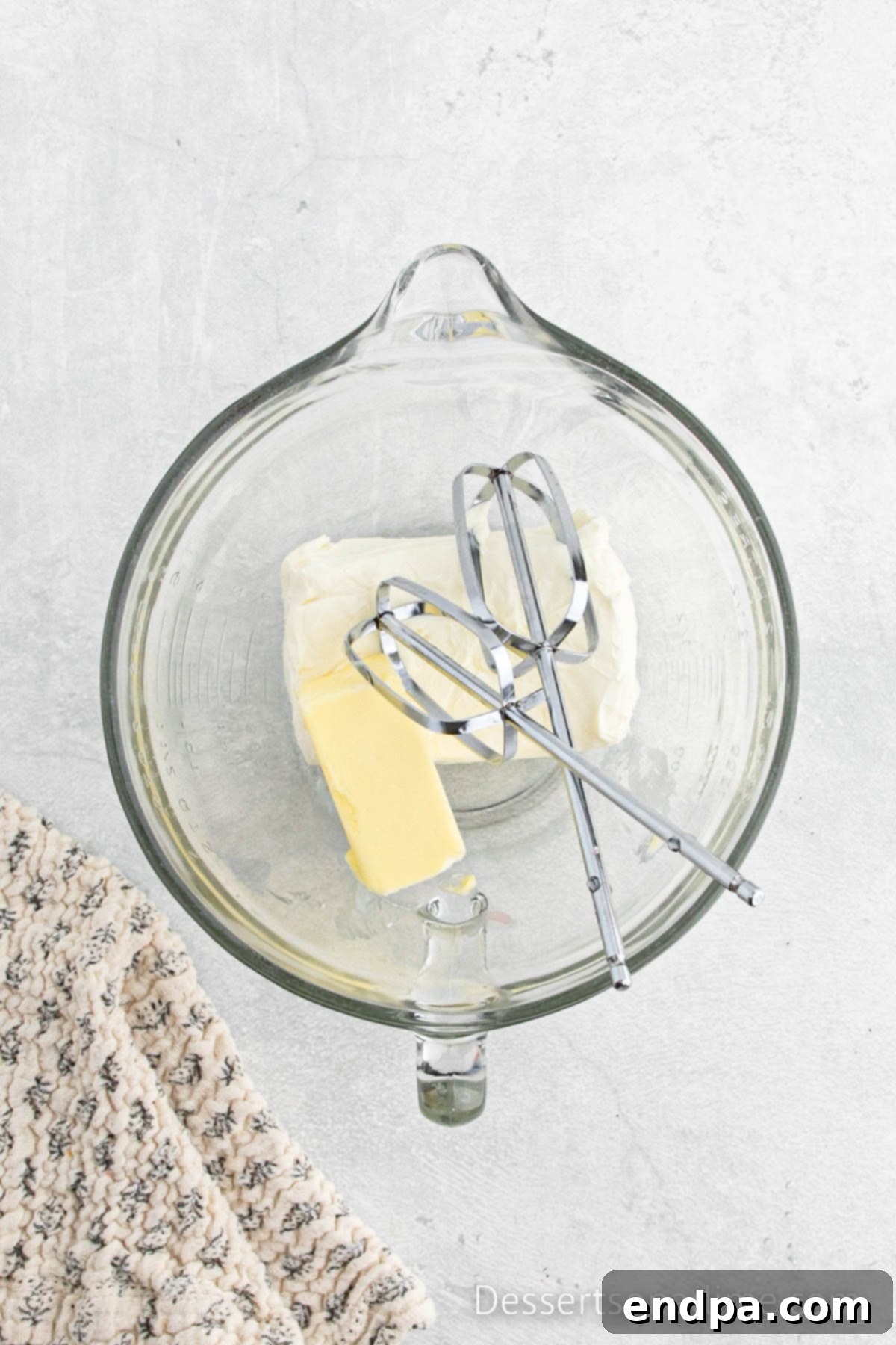 Paula Deen's Signature Strawberry Cake 8 Softened butter and cream cheese being beaten together in a large mixing bowl with an electric mixer for the frosting.