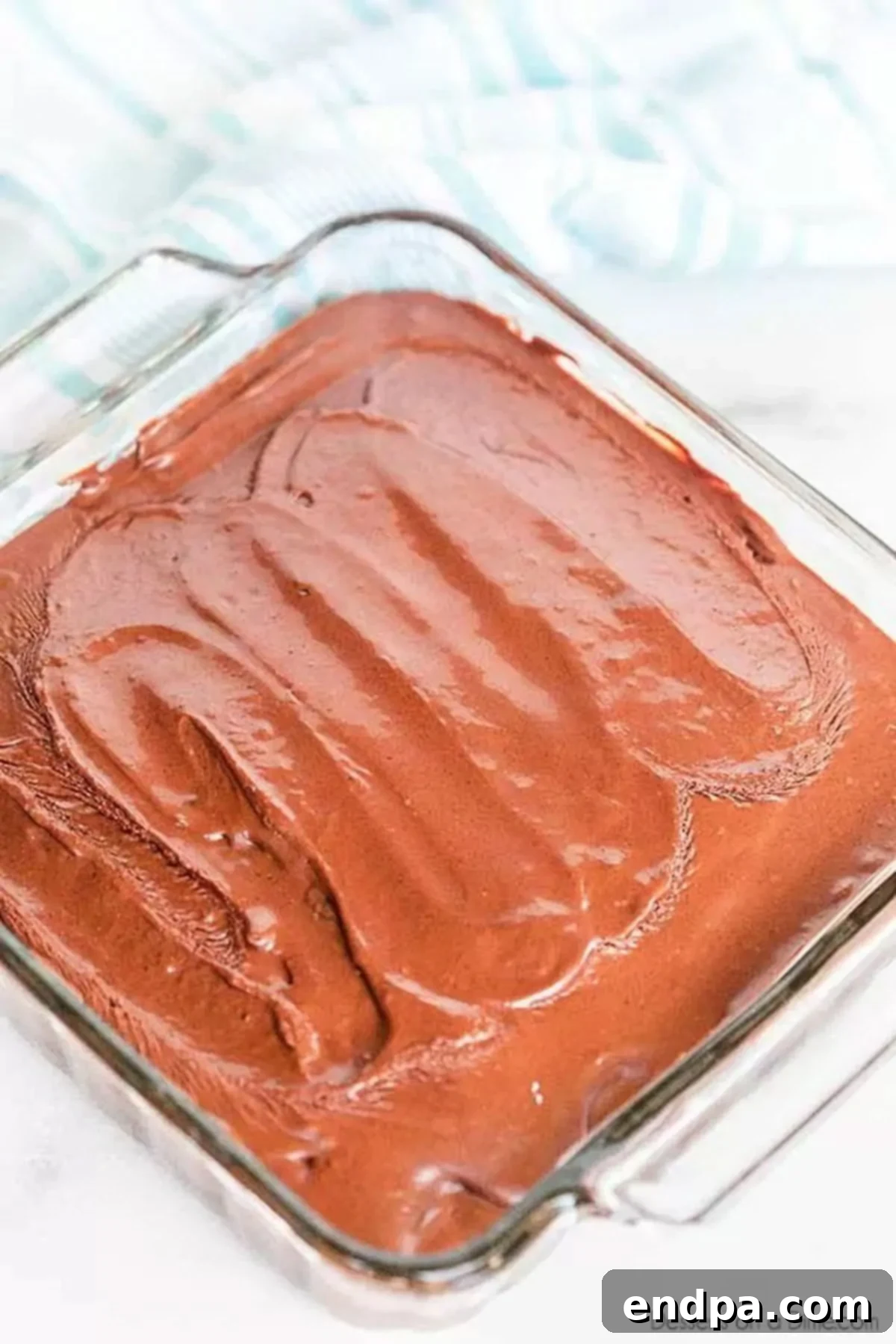 A whole 8x8 pan of depression cake that is frosted.