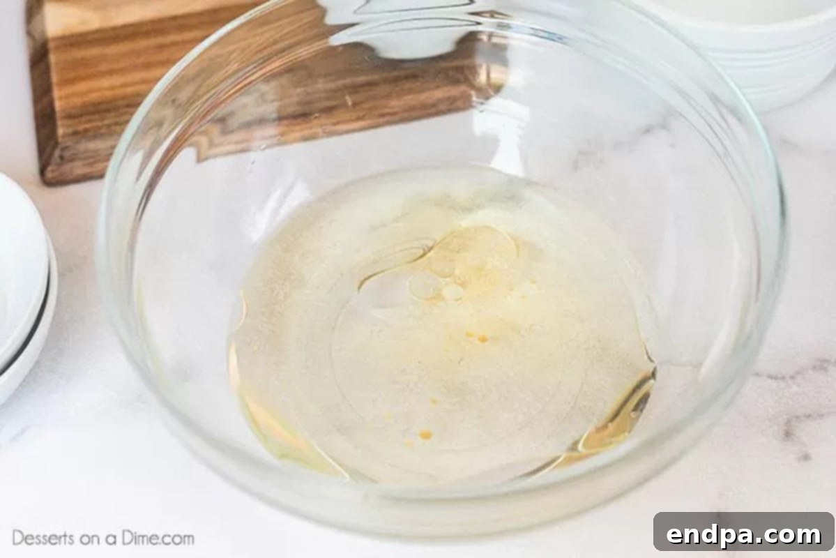 Combining the vanilla, vinegar, oil and water