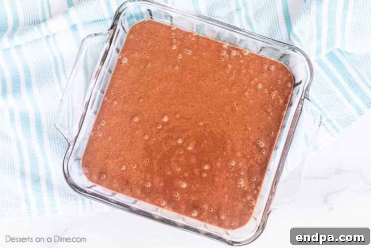 Cake batter poured into a 8x8 baking dish