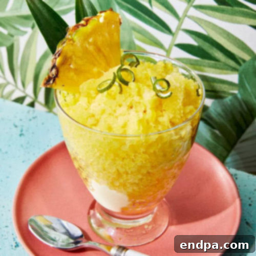 A bowl of icy, refreshing Pineapple Granita, garnished with fresh mint.