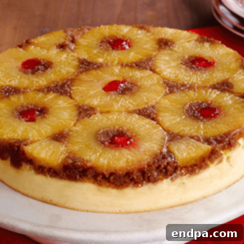 A decadent Pineapple Upside Down Cheesecake with a golden pineapple topping and a creamy cheesecake base.