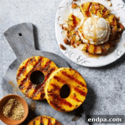 Sweet and smoky Grilled Pineapple Sundaes, topped with a drizzle of olive oil and almonds.