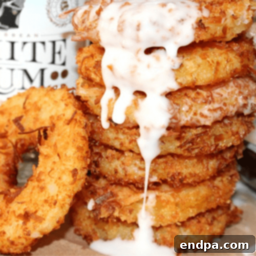 Crispy Deep Fried Pina Colada Rings, dusted with powdered sugar.