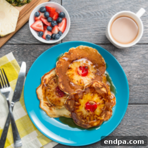 Fluffy Pineapple Upside Down Pancakes, showing caramelized pineapple slices and a buttery sauce.