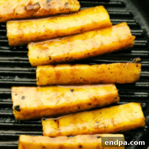 Grilled pineapple spears coated in a delicious caramelized brown sugar cinnamon glaze.