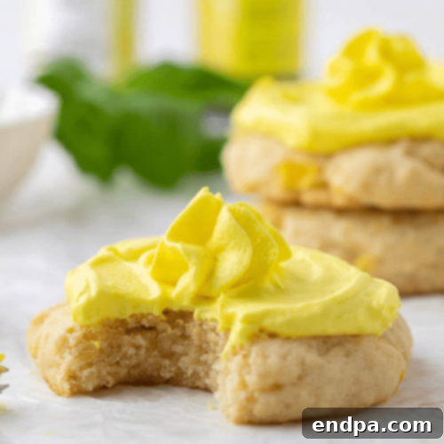 Soft Crumbl Pineapple Dole Whip Cookies topped with a swirl of pineapple frosting.