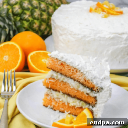 A beautifully layered Hawaiian Sunset Cake with a fruity filling and vibrant colors.