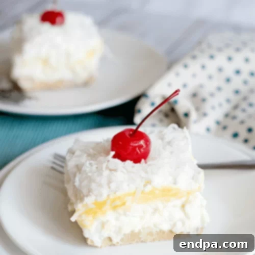 A creamy, no-bake Pina Colada Lush Cake with layers of tropical goodness.