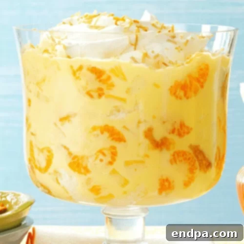 A refreshing Pineapple Orange Trifle with layers of coconut, pineapple, and mandarin oranges.