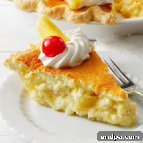A slice of Lemon Sponge Pie with Pineapple, showing a fluffy top layer and a creamy custard base.