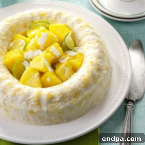 A decorative Pina Colada Molded Salad, shaped into a gelatin ring with tropical fruits.