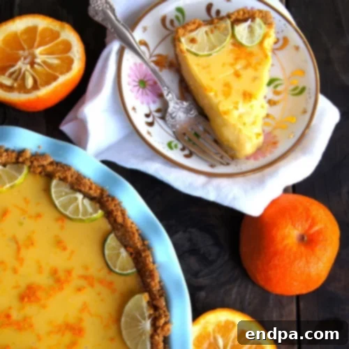 The Ultimate Collection of Tangy Lime Desserts 4 Orange key lime pie with a cardamom crust, garnished with orange slices and whipped cream.