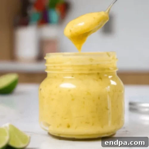 The Ultimate Collection of Tangy Lime Desserts 6 Smooth, vibrant green lime curd in a glass jar, garnished with fresh lime zest.