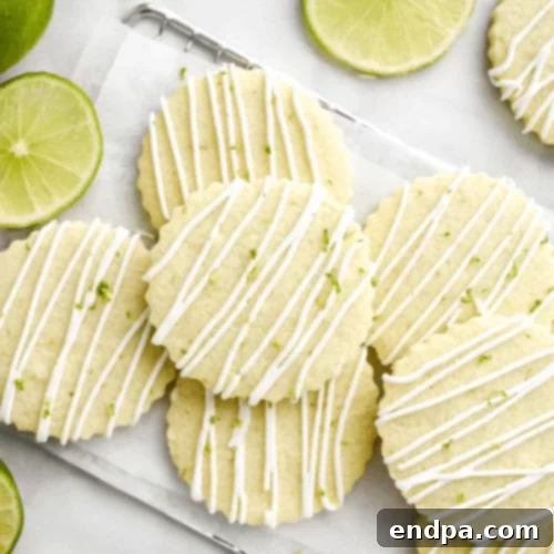 The Ultimate Collection of Tangy Lime Desserts 7 Sugar cookies with lime glaze and a hint of tequila, garnished with lime wedges.
