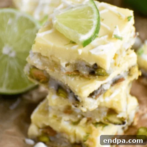 The Ultimate Collection of Tangy Lime Desserts 16 White chocolate key lime bars with a pistachio crust, garnished with lime zest.