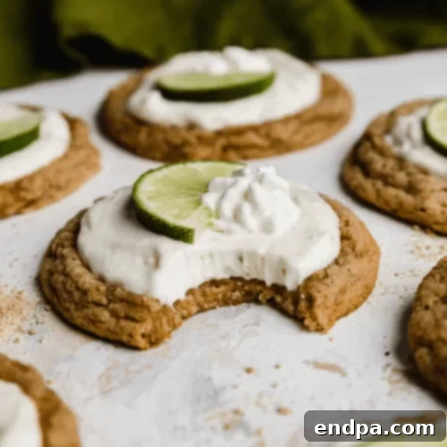 The Ultimate Collection of Tangy Lime Desserts 22 Crumbl copycat key lime pie cookies with lime filling and a lime slice.