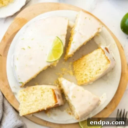 The Ultimate Collection of Tangy Lime Desserts 35 Slice of lime and coconut cake with a green glaze and shredded coconut.
