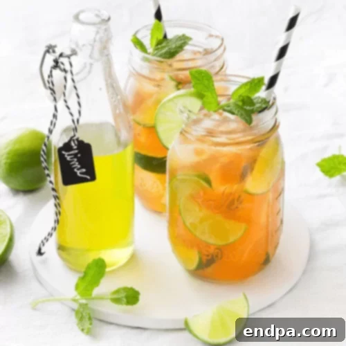 The Ultimate Collection of Tangy Lime Desserts 48 Lady Grey lime cooler in a tall glass with lime slices and mint.