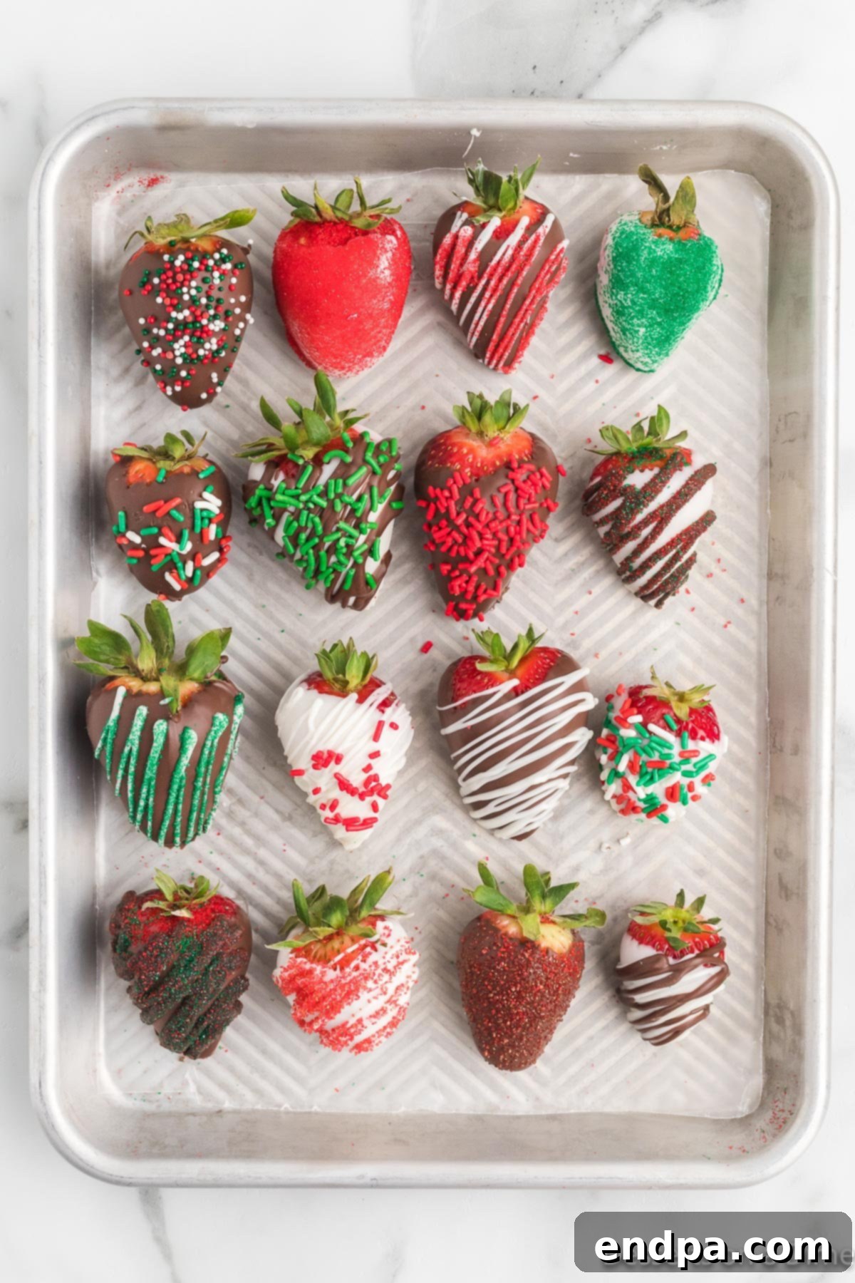 Yuletide Chocolate Strawberries 6 Baking sheet filled with chocolate covered strawberries, freshly topped with festive sprinkles.