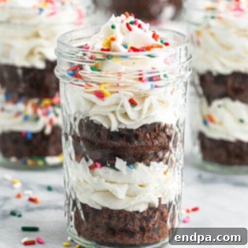 Delightful Cupcakes in a Jar, layered with cake, frosting, and colorful sprinkles, perfect for a personalized treat.