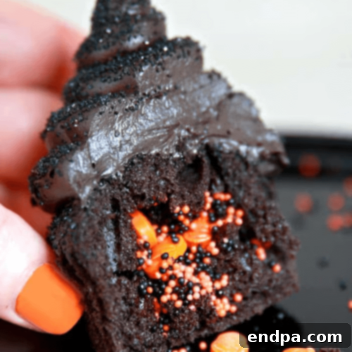 Dark and decadent Halloween Chocolate Cupcakes topped with black frosting and festive sprinkles.