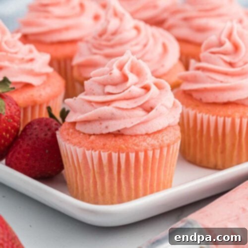 Whimsical Monster Cupcakes topped with vibrant, shaggy frosting and playful candy eyes.