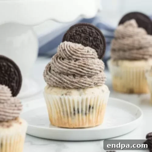Indulgent Oreo Cupcakes topped with creamy white frosting, crumbled Oreos, and a whole Oreo cookie.