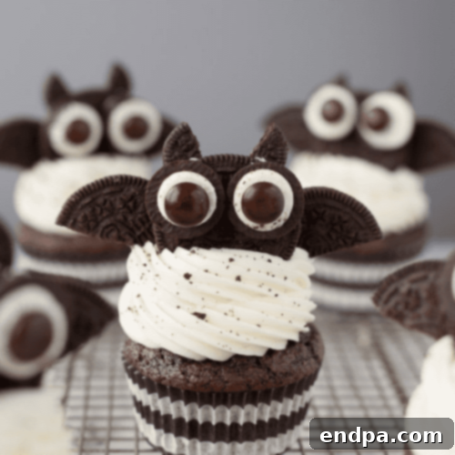Charming Oreo Bat Cupcakes with frosting, halved Oreo cookies for wings, and candy eyes.