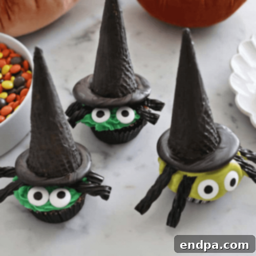 Charming Witch Cupcakes for Halloween, topped with pointed witch hats made from cookies and chocolate.