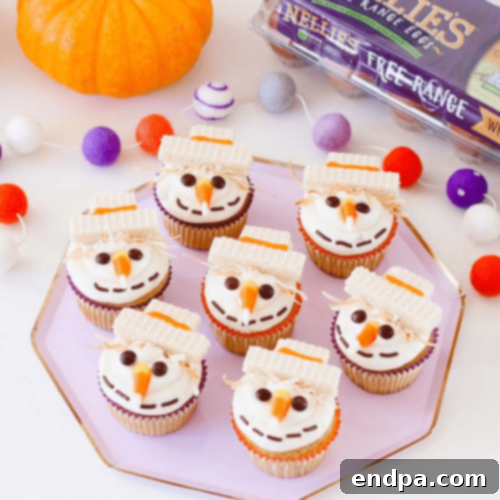 Adorable Pumpkin Spice Scarecrow Cupcakes decorated with cheerful scarecrow faces and edible straw details.