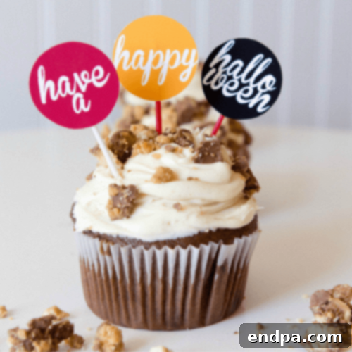 Colorful Halloween Candy Cupcakes overloaded with a variety of festive candies and sprinkles.