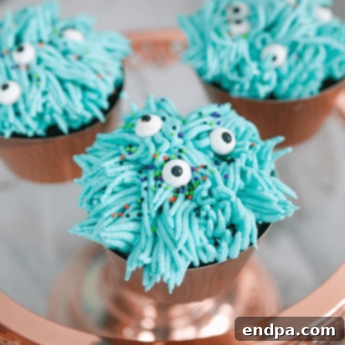 Whimsical Halloween Silly Monsters Cupcakes with vibrant, textured frosting and playful candy eyeballs.