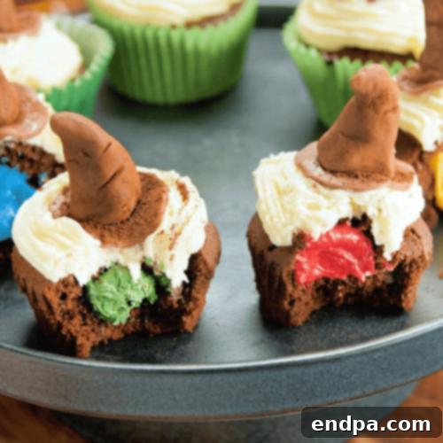 Magical Harry Potter Sorting Hat Cupcakes, topped with a chocolate sorting hat and house-colored frosting.