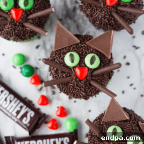 Chic Black Cat Halloween Cupcakes featuring dark frosting and elegant black cat silhouette decorations.