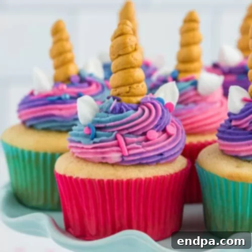 A whimsical arrangement of Unicorn Cupcakes, adorned with colorful frosting, sprinkles, and edible unicorn horns and ears.