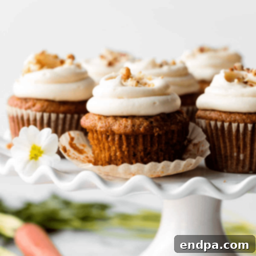 Moist and flavorful Carrot Cake Cupcakes crowned with a luscious swirl of cream cheese frosting.