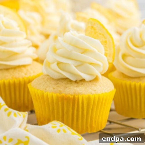 Bright and zesty Lemon Cupcakes adorned with a swirl of lemon buttercream frosting and a fresh lemon slice.