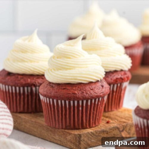 Elegant Red Velvet Cupcakes crowned with luscious cream cheese frosting, perfect for any celebration.