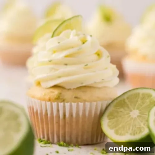 Zesty Margarita Cupcakes topped with a swirl of lime frosting and a sprinkle of salt, ready to be enjoyed.