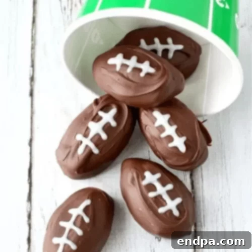 Football shaped chocolate peanut butter balls on a plate.